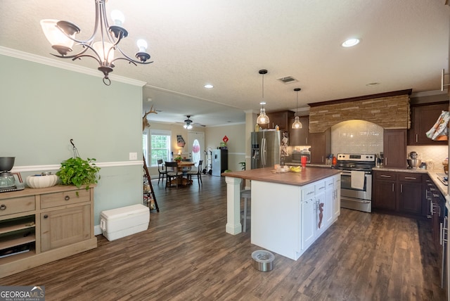 3251 Harrell Rd, Whigham, GA 39897 - kitchen with stainless steel appliances, backsplash, ceiling fan, dark wood-style flooring, and ornamental molding