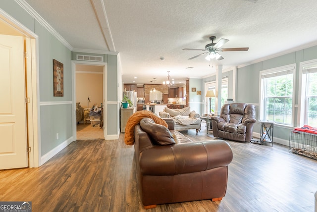 3251 Harrell Rd, Whigham, GA 39897 - living room featuring ornamental molding, ceiling fan, wood finished floors, a textured ceiling, and a chandelier
