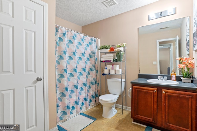 5865 El Segundo Way, Atlanta, GA 30349 - bathroom with toilet, vanity, a textured ceiling, a shower with curtain, and tile patterned floors