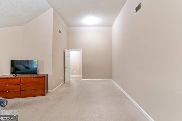5865 El Segundo Way, Atlanta, GA 30349 - unfurnished living room with a textured ceiling, baseboards, and light colored carpet