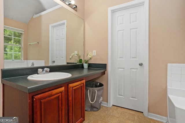 5865 El Segundo Way, Atlanta, GA 30349 - full bathroom featuring vanity, a tub to relax in, baseboards, and ornamental molding