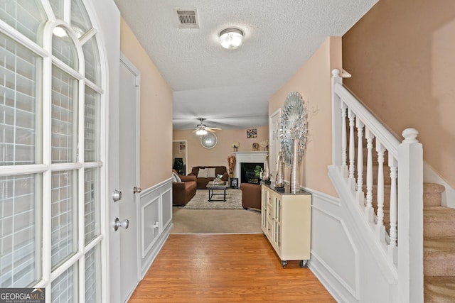 5865 El Segundo Way, Atlanta, GA 30349 - entryway with a textured ceiling, light wood-type flooring, stairway, wainscoting, and a ceiling fan