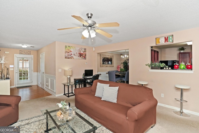 5865 El Segundo Way, Atlanta, GA 30349 - living area featuring carpet floors, ceiling fan, a textured ceiling, baseboards, and a chandelier