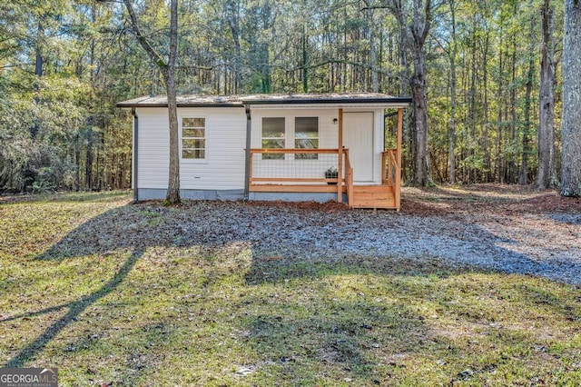 580 Vaughn Rd, Griffin, GA 30223 - view of outdoor structure featuring a view of trees and covered porch