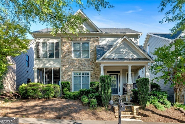 4845 Backbay St, Suwanee, GA 30024 - view of front of home with stone siding, a standing seam roof, and a metal roof