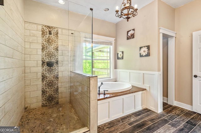 68 Riveree Rd, Brooks, GA 30205 - bathroom with a bath, a walk in shower, a chandelier, wood finish floors, and a wainscoted wall