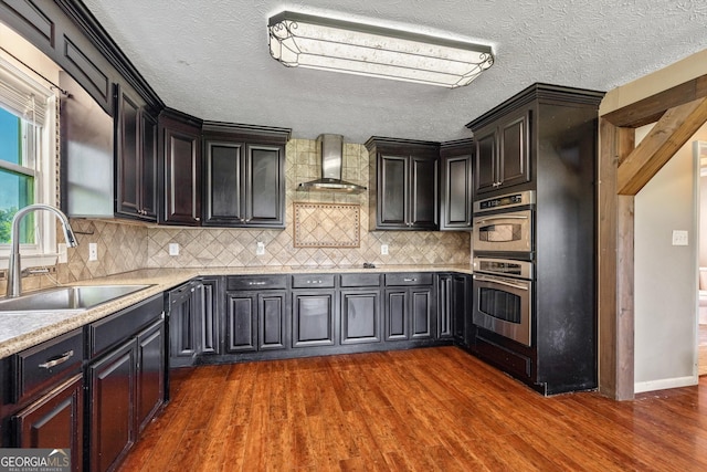 68 Riveree Rd, Brooks, GA 30205 - kitchen with wall chimney exhaust hood, stainless steel double oven, dark wood-style floors, light countertops, and backsplash