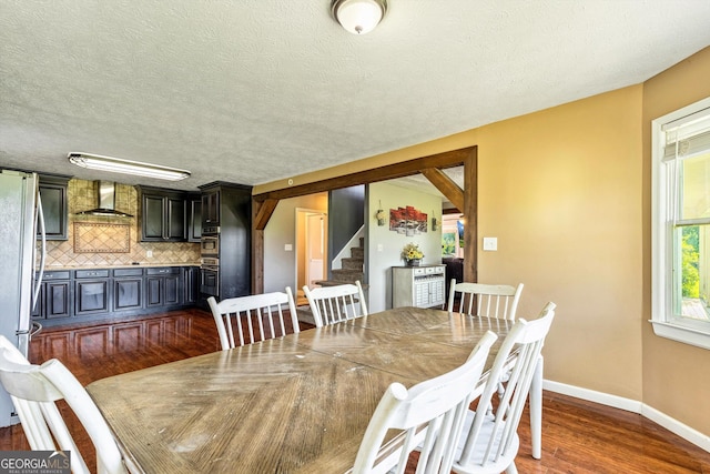 68 Riveree Rd, Brooks, GA 30205 - dining room with stairs, dark wood-style flooring, and a textured ceiling