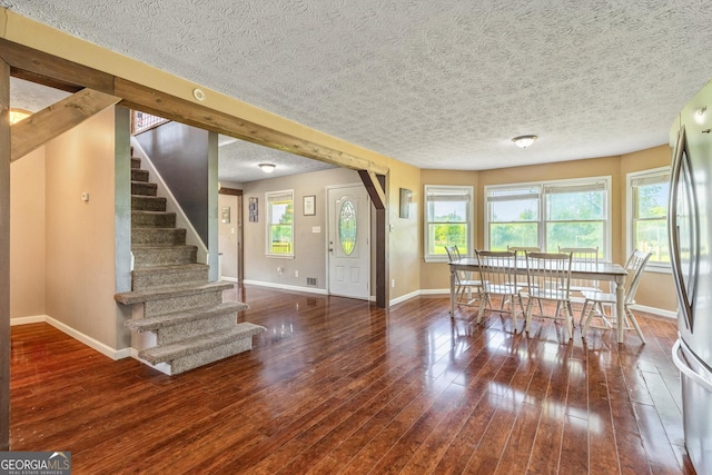 68 Riveree Rd, Brooks, GA 30205 - unfurnished dining area featuring healthy amount of natural light, stairway, a textured ceiling, and wood finished floors