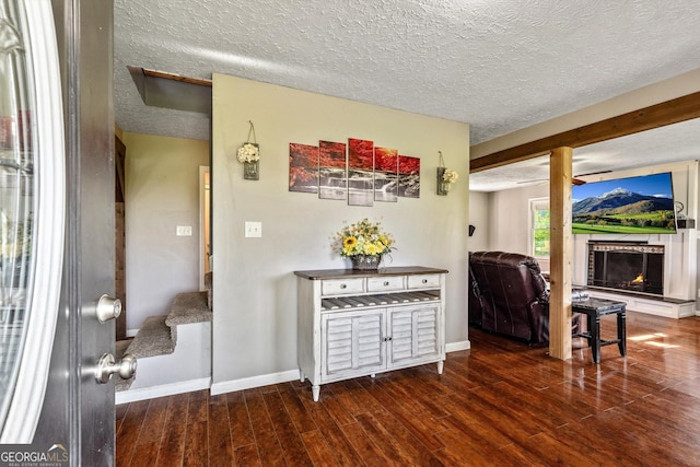 68 Riveree Rd, Brooks, GA 30205 - interior space featuring a textured ceiling, wood finished floors, and a lit fireplace