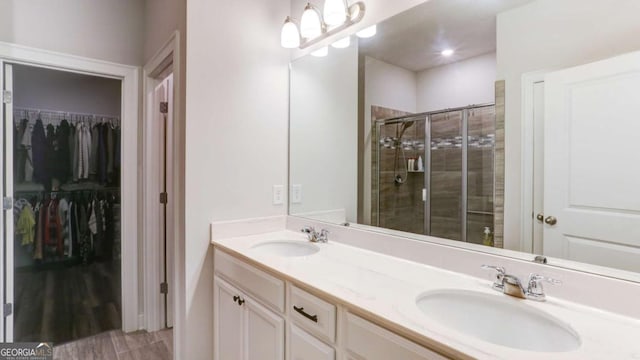 3410 Summerpoint Xing, Cumming, GA 30028 - bathroom featuring a shower stall, double vanity, and a walk in closet