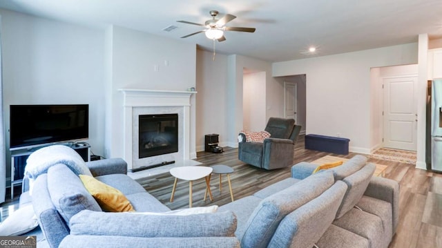 3410 Summerpoint Xing, Cumming, GA 30028 - living room featuring ceiling fan, wood finished floors, baseboards, recessed lighting, and a high end fireplace