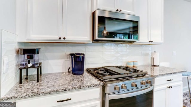 3410 Summerpoint Xing, Cumming, GA 30028 - kitchen featuring stainless steel appliances, tasteful backsplash, and white cabinets
