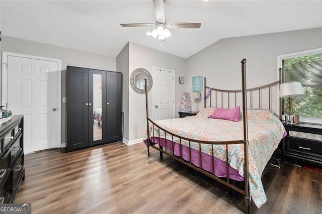 10650 Colony Glen Dr, Johns Creek, GA 30022 - bedroom with wood finished floors, lofted ceiling, baseboards, and a ceiling fan
