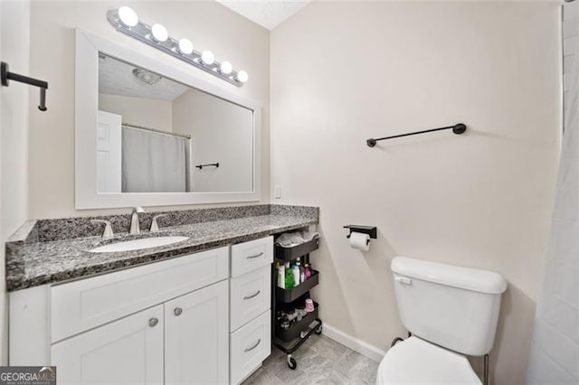 10650 Colony Glen Dr, Johns Creek, GA 30022 - full bathroom with toilet, baseboards, and vanity