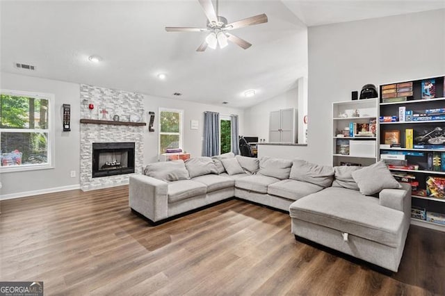 10650 Colony Glen Dr, Johns Creek, GA 30022 - living area featuring vaulted ceiling, wood finished floors, plenty of natural light, ceiling fan, and a fireplace