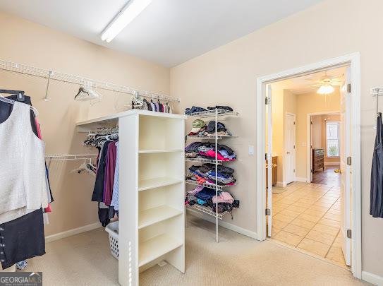 2810 Promenade Pl, Buford, GA 30519 - walk in closet featuring carpet flooring and tile patterned flooring