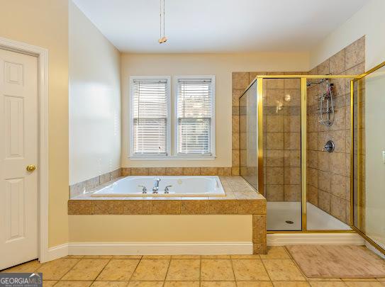 2810 Promenade Pl, Buford, GA 30519 - bathroom with a garden tub, a stall shower, and tile patterned flooring