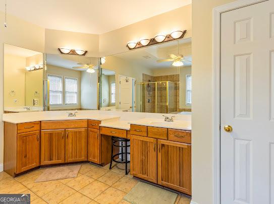 2810 Promenade Pl, Buford, GA 30519 - bathroom with ceiling fan, a shower stall, double vanity, and tile patterned flooring