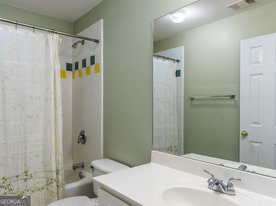 2810 Promenade Pl, Buford, GA 30519 - bathroom with toilet, vanity, and shower / bath combo with shower curtain