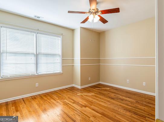 2810 Promenade Pl, Buford, GA 30519 - empty room with a ceiling fan, baseboards, and light wood-style flooring