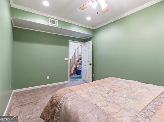 2810 Promenade Pl, Buford, GA 30519 - carpeted bedroom with ornamental molding, baseboards, a walk in closet, recessed lighting, and a ceiling fan