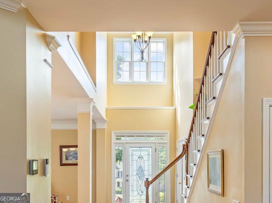 2810 Promenade Pl, Buford, GA 30519 - foyer entrance featuring a towering ceiling, stairway, a chandelier, and healthy amount of natural light