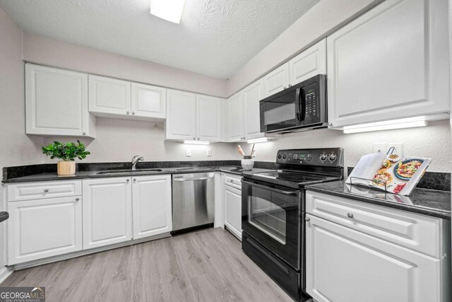 705 Beaufort Cir, Duluth, GA 30096 - kitchen featuring black appliances, a sink, light wood-style floors, white cabinets, and a textured ceiling