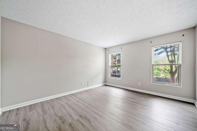 705 Beaufort Cir, Duluth, GA 30096 - spare room featuring a textured ceiling, wood finished floors, and baseboards