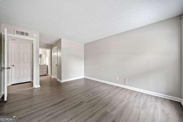 705 Beaufort Cir, Duluth, GA 30096 - spare room featuring dark wood-type flooring, baseboards, and a textured ceiling