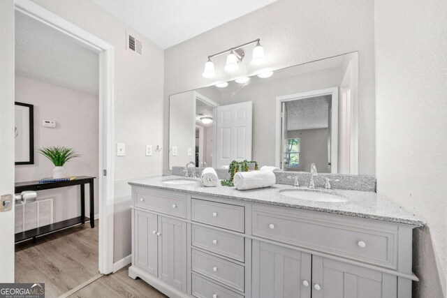 705 Beaufort Cir, Duluth, GA 30096 - full bathroom featuring wood finished floors and double vanity