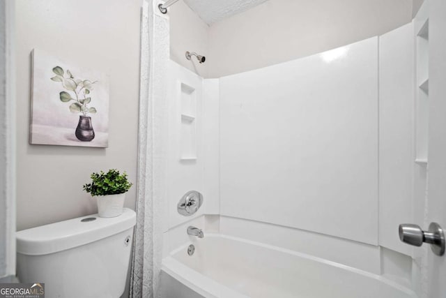 705 Beaufort Cir, Duluth, GA 30096 - bathroom with toilet, tub / shower combination, and a textured ceiling