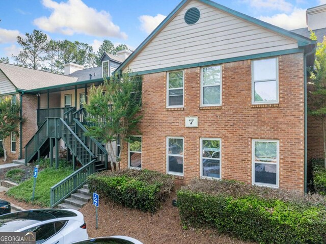 705 Beaufort Cir, Duluth, GA 30096 - view of building exterior with stairs, uncovered parking, and cooling unit