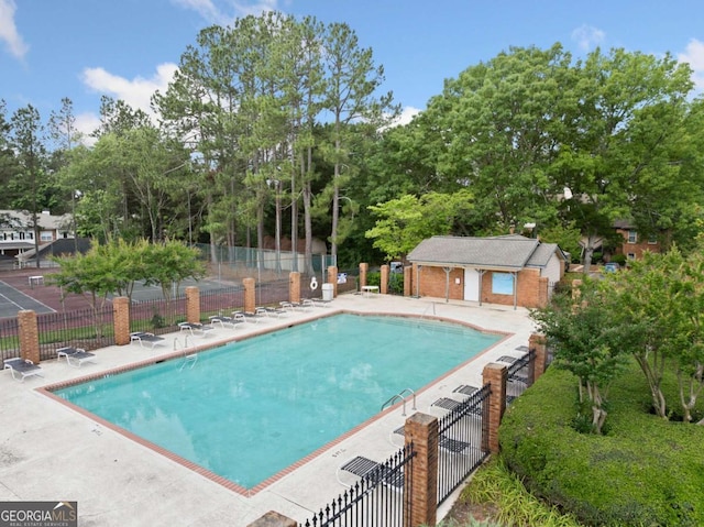 705 Beaufort Cir, Duluth, GA 30096 - community pool with a patio area and view of wooded area