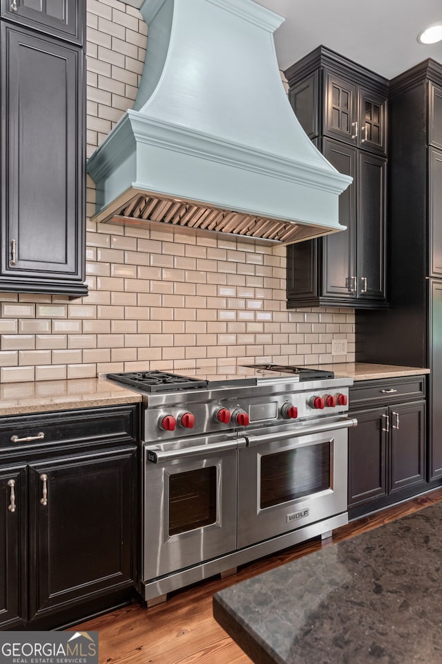 441 Crumbley Rd, Mcdonough, GA 30252 - kitchen featuring double oven range, premium range hood, decorative backsplash, and light stone countertops