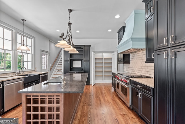 441 Crumbley Rd, Mcdonough, GA 30252 - kitchen featuring stainless steel appliances, a sink, premium range hood, tasteful backsplash, and dark stone countertops