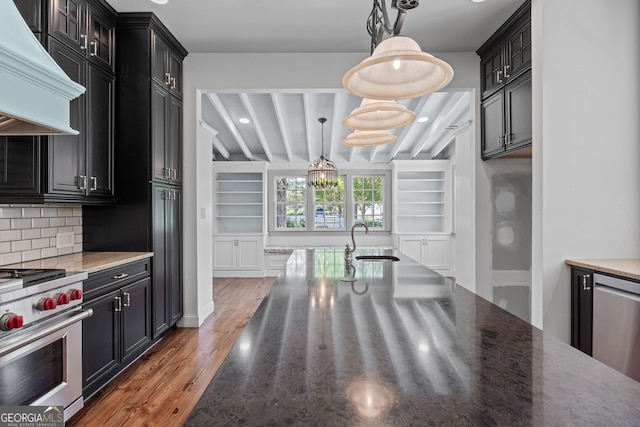 441 Crumbley Rd, Mcdonough, GA 30252 - kitchen featuring custom range hood, stainless steel appliances, wood finished floors, a sink, and decorative backsplash