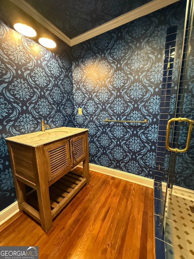 441 Crumbley Rd, Mcdonough, GA 30252 - full bath featuring wood finished floors, wallpapered walls, baseboards, crown molding, and a stall shower