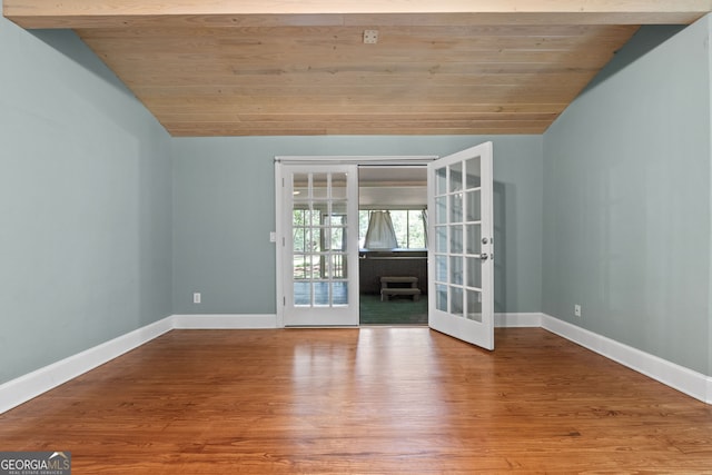 441 Crumbley Rd, Mcdonough, GA 30252 - unfurnished room featuring french doors, vaulted ceiling, baseboards, wood ceiling, and wood finished floors