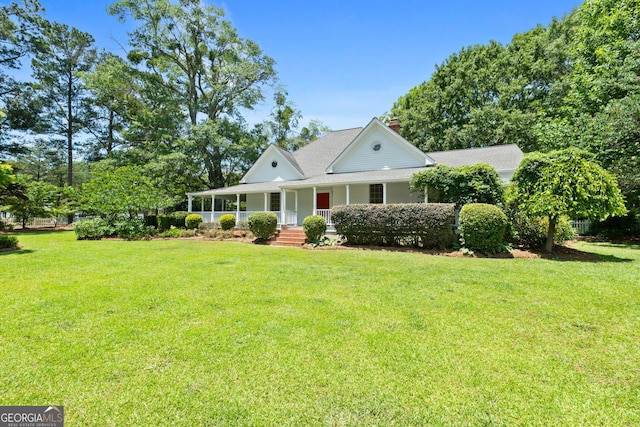 441 Crumbley Rd, Mcdonough, GA 30252 - farmhouse featuring a porch, a front yard, and a chimney