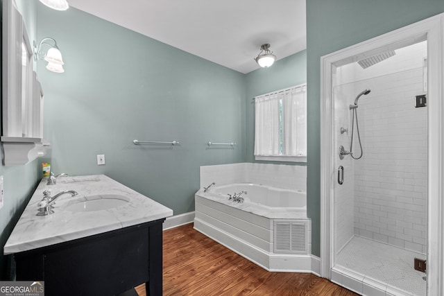 441 Crumbley Rd, Mcdonough, GA 30252 - bathroom featuring a shower stall, a bath, baseboards, wood finished floors, and double vanity