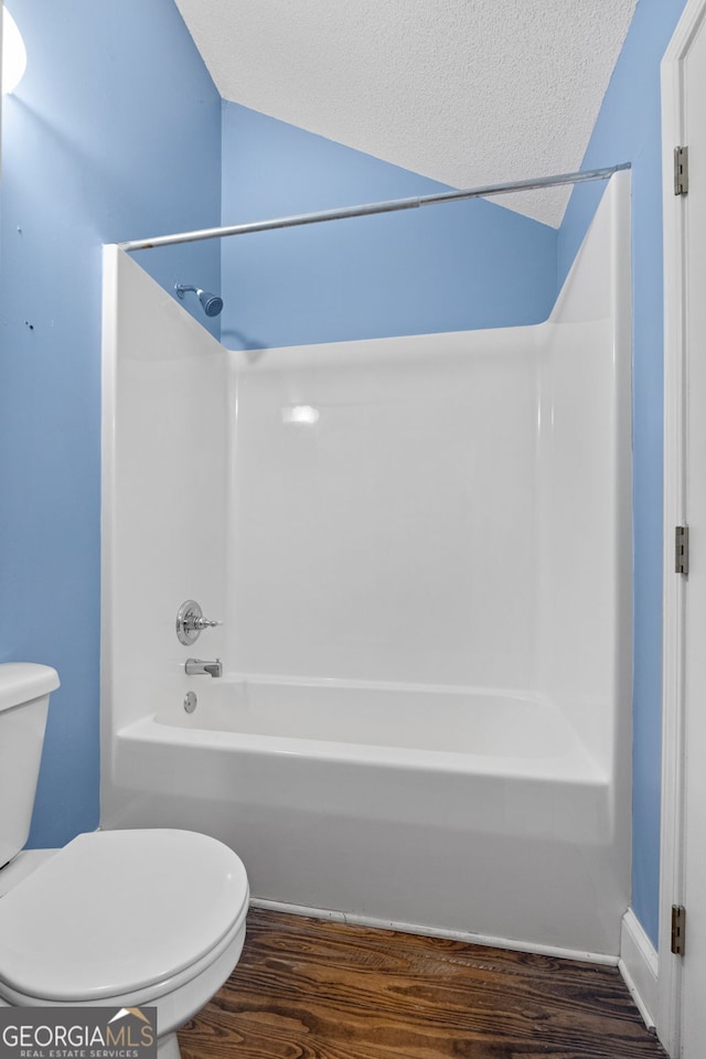 441 Crumbley Rd, Mcdonough, GA 30252 - full bathroom with wood finished floors, toilet, tub / shower combination, and a textured ceiling