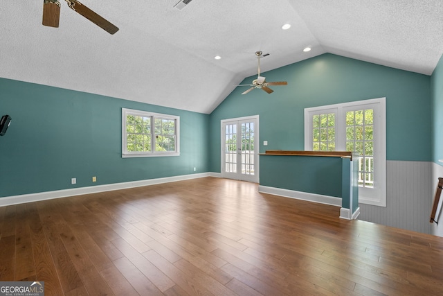 441 Crumbley Rd, Mcdonough, GA 30252 - unfurnished living room featuring ceiling fan, a textured ceiling, lofted ceiling, wood finished floors, and baseboards