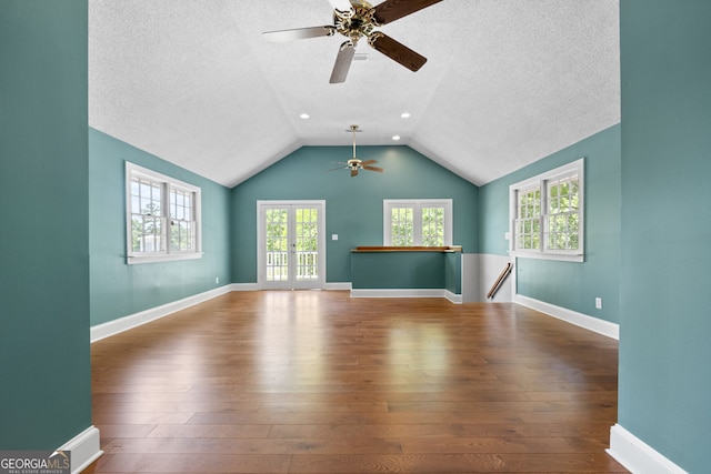 441 Crumbley Rd, Mcdonough, GA 30252 - unfurnished living room featuring a ceiling fan, wood-type flooring, a textured ceiling, healthy amount of natural light, and lofted ceiling