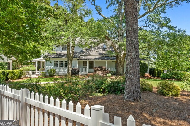 441 Crumbley Rd, Mcdonough, GA 30252 - view of property hidden behind natural elements featuring a fenced front yard and a porch