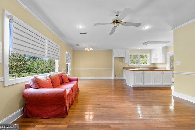 441 Crumbley Rd, Mcdonough, GA 30252 - living area featuring recessed lighting, light wood finished floors, a ceiling fan, baseboards, and ornamental molding