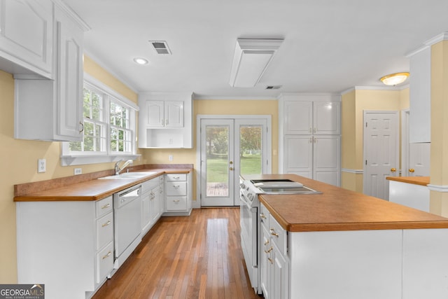 441 Crumbley Rd, Mcdonough, GA 30252 - kitchen with white appliances, a sink, white cabinets, light wood-style flooring, and a center island