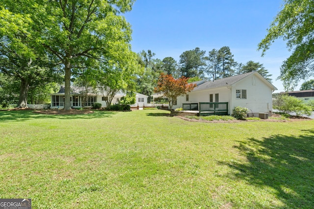 441 Crumbley Rd, Mcdonough, GA 30252 - view of green lawn with a wooden deck and central AC