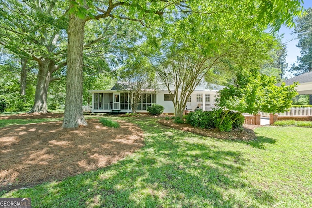 441 Crumbley Rd, Mcdonough, GA 30252 - rear view of house with a sunroom and a lawn