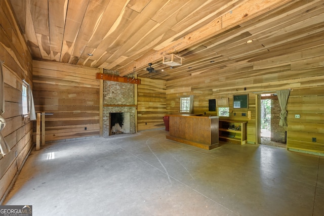 441 Crumbley Rd, Mcdonough, GA 30252 - unfurnished living room with concrete flooring, wooden walls, and a fireplace